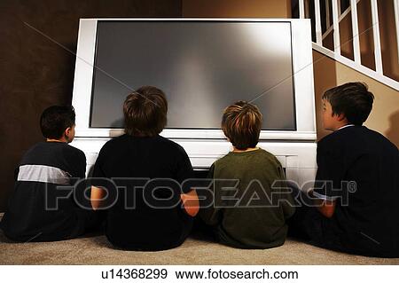 Young boys in front of a television View Large Photo Image Stock Photo - Young boys in front of a television. Fotosearch