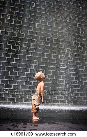 A boy standing beside a wall fountain, Chicago, Illinois, USA View Large Photo Image Stock Photo - A boy standing beside a wall fountain, Chicago, Illinois, USA. Fotosearch