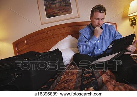 A businessman reviewing some notes View Large Photo Image Stock Photo - A businessman reviewing some notes. Fotosearch