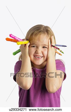 A girl holding crayons and markers View Large Photo Image Stock Image - A girl holding crayons and markers. Fotosearch