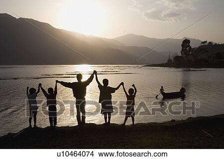 Picture - A group of people with arms raised. Fotosearch