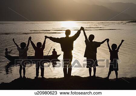A group of people with arms raised View Large Photo Image Stock Image - A group of people with arms raised . Fotosearch
