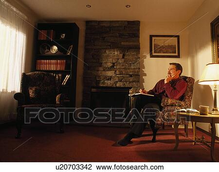 Stock Image - A man sitting in his study. Fotosearch