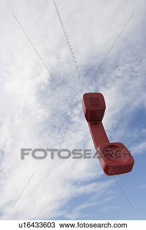A telephone receiver dangling from the sky View Large Photo Image Stock Image - A telephone receiver dangling from the sky. Fotosearch