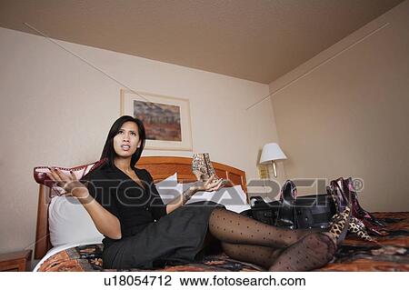 A woman comparing shoes View Large Photo Image Stock Image - A woman comparing shoes. Fotosearch