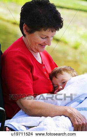 A woman holding her grandson View Large Photo Image Picture - A woman holding her grandson. Fotosearch