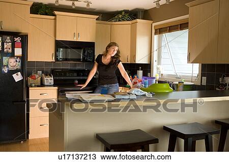 A woman in a kitchen View Large Photo Image Stock Image - A woman in a kitchen. Fotosearch
