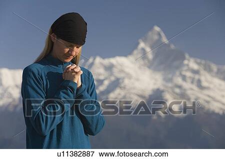 A woman in prayer View Large Photo Image Stock Photo - A woman in prayer. Fotosearch