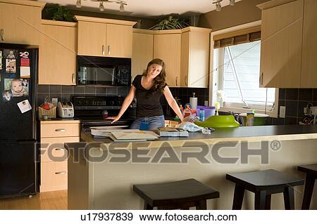 A woman in the kitchen View Large Photo Image Stock Photo - A woman in the kitchen. Fotosearch