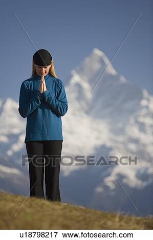 Stock Photo - A woman praying. Fotosearch