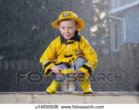 Boy in the rain View Large Photo Image Stock Photograph - Boy in the rain. Fotosearch