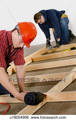 Carpenters building a frame View Large Photo Image Stock Photograph - Carpenters building a frame. Fotosearch