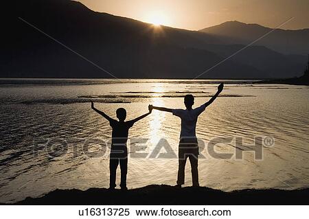 Children holding hands stretched up to the sky View Large Photo Image Stock Photography - Children holding hands stretched up to the sky . Fotosearch