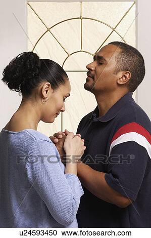 Couple praying together View Large Photo Image Stock Image - Couple praying together. Fotosearch