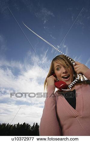 Front view of woman talking on phone View Large Photo Image Stock Photo - Front view of woman talking on phone. Fotosearch