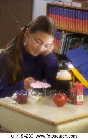 Girl eating lunch at desk View Large Photo Image Stock Image - Girl eating lunch at desk. Fotosearch