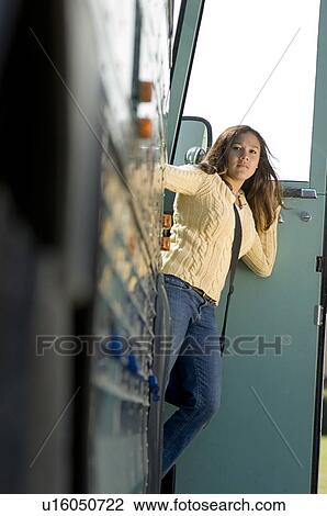 Stock Image - Girl leaning out of bus. Fotosearch