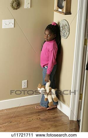 Girl standing in the corner View Large Photo Image Stock Image - Girl standing in the corner. Fotosearch