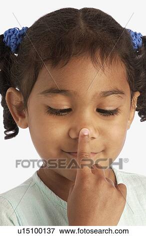 Stock Photo - Girl touching her nose . Fotosearch