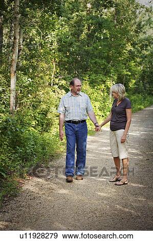 Husband and wife on walking trail View Large Photo Image Stock Photo - Husband and wife on walking trail. Fotosearch