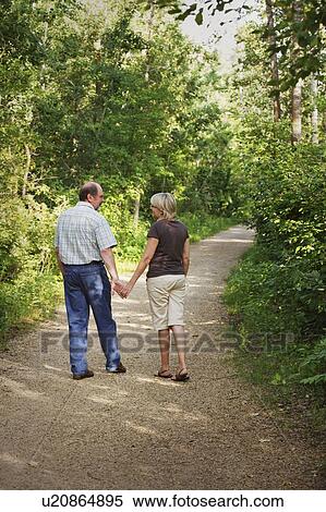 Stock Photography - Husband and wife on walking trail. Fotosearch