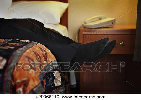 Male feet hanging off of bed View Large Photo Image Stock Image - Male feet hanging off of bed. Fotosearch