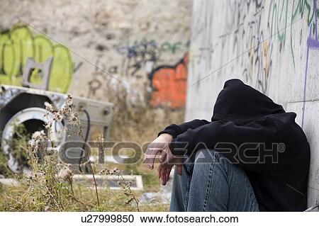 Stock Image - Man beside graffiti. Fotosearch