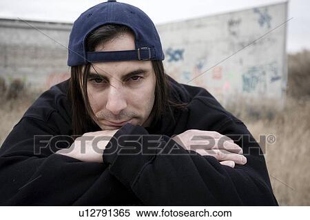 Stock Photography - Man beside wall. Fotosearch