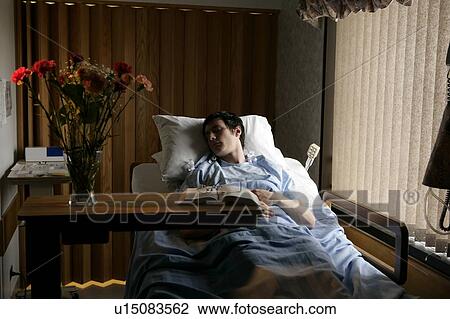 Stock Image - Man in a hospital bed. Fotosearch