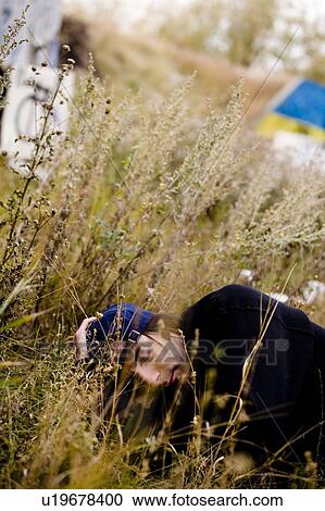 Man lying in long grass View Large Photo Image Stock Image - Man lying in long grass. Fotosearch
