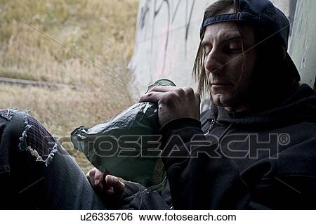 Man with bottle of alcohol View Large Photo Image Stock Photograph - Man with bottle of alcohol. Fotosearch