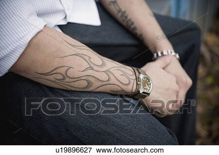 Man with tattooed arms View Large Photo Image Stock Photo - Man with tattooed arms . Fotosearch