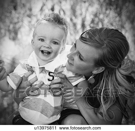 Mother and son laughing together View Large Photo Image Stock Image - Mother and son laughing together. Fotosearch