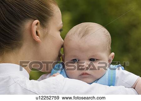 Stock Photo - Mother holding baby boy. Fotosearch