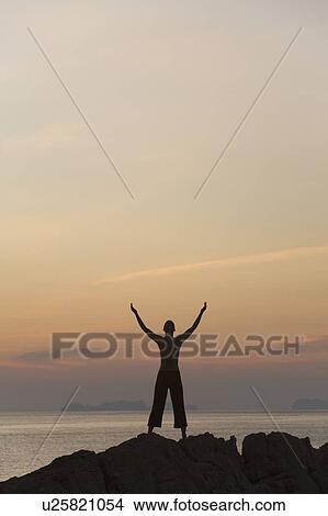 Picture - Person with arms raised. Fotosearch