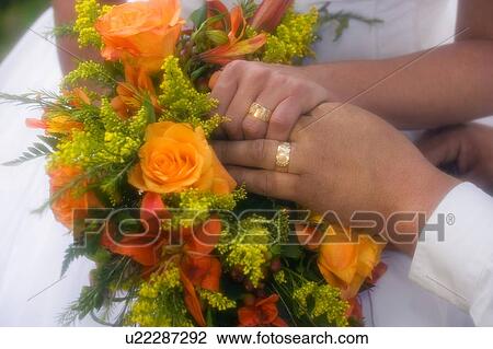 Stock Image - Rings on Bride and Grooms fingers . Fotosearch