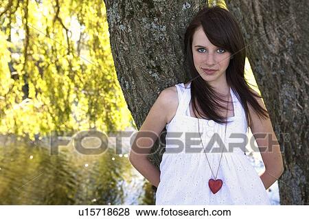 Teen girl with a heart necklace View Large Photo Image Stock Photo - Teen girl with a heart necklace. Fotosearch