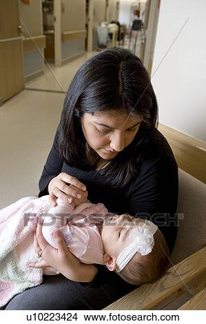 Picture - Woman holding baby girl. Fotosearch