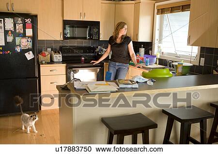 Woman in a kitchen View Large Photo Image Stock Image - Woman in a kitchen. Fotosearch
