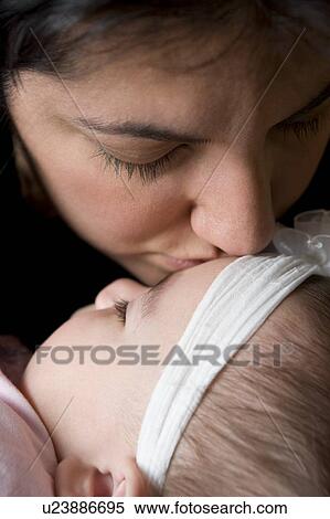 Woman kissing baby girl View Large Photo Image Stock Photography - Woman kissing baby girl. Fotosearch