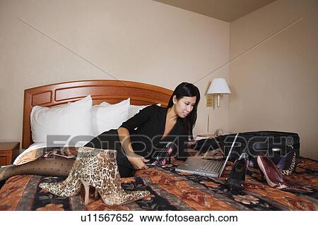 Woman on computer surrounded by shoes View Large Photo Image Stock Image - Woman on computer surrounded by shoes. Fotosearch