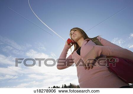 Woman talking on a phone View Large Photo Image Stock Photograph - Woman talking on a phone. Fotosearch