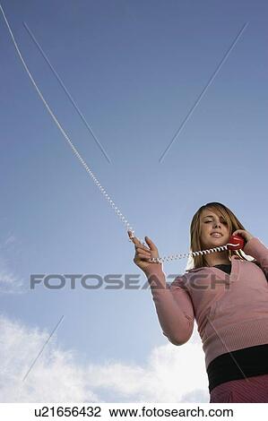 Stock Image - Woman talking on phone. Fotosearch
