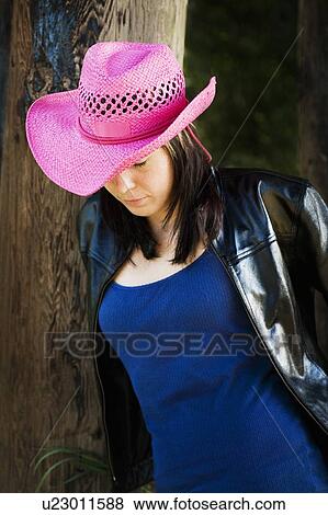 Woman wearing pink cowboy hat View Large Photo Image Stock Photo - Woman wearing pink cowboy hat. Fotosearch