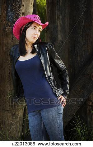 Stock Photograph - Woman wearing pink cowboy hat. Fotosearch