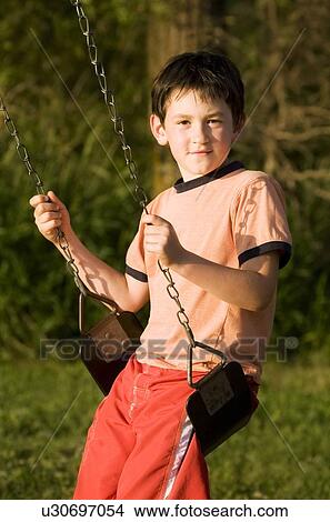 A boy on a swing View Large Photo Image Picture - A boy on a swing. Fotosearch