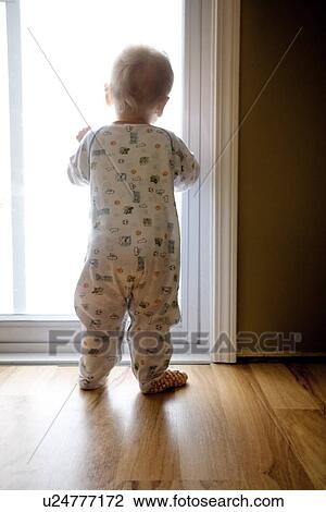 Baby looking out the window View Large Photo Image Stock Image - Baby looking out the window. Fotosearch