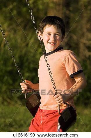 Boy on a swing View Large Photo Image Stock Image - Boy on a swing. Fotosearch