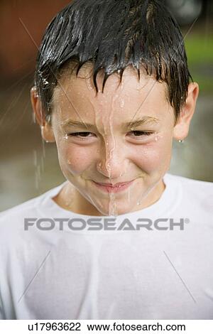 Stock Image - Boy with water dripping from head. Fotosearch