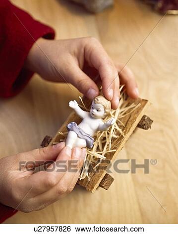 Child playing with figure of baby Jesus View Large Photo Image Stock Photograph - Child playing with figure of baby Jesus. Fotosearch